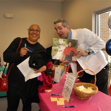 Millersville dentist Doctor Jay McCarl posing with dental patient at BWMC Heartbeat for Health event