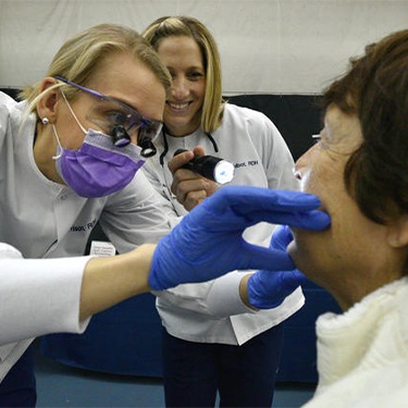 Millersville dental team members Ashley and Kim performing oral cancer screening during BWMC Heartbeat for Health event