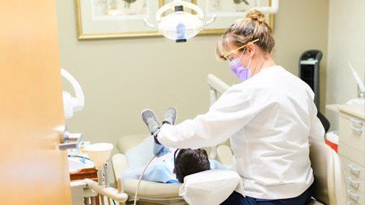 Team member treating young dental patient