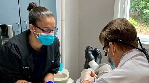 Dr. Clayton and team member treating dental patient