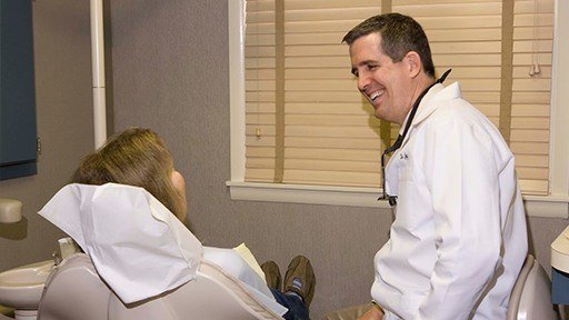 Millersville implant dentist and patient discussing dental implants