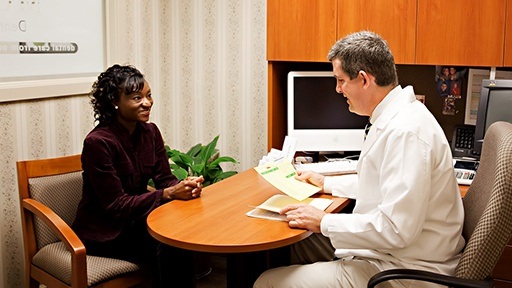 Dr. David McCarl talking to dental patient