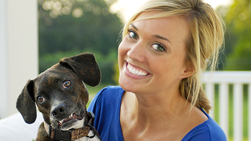 Smiling woman with a dog