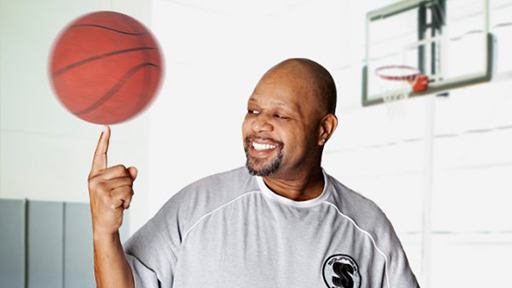 Man spinning a basketball on his fingertip