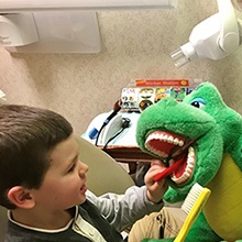 Child practicing tooth brushing