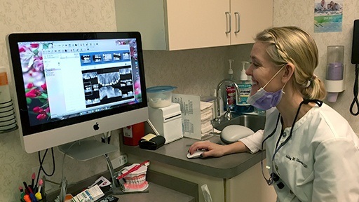 Team member looking at smile design software