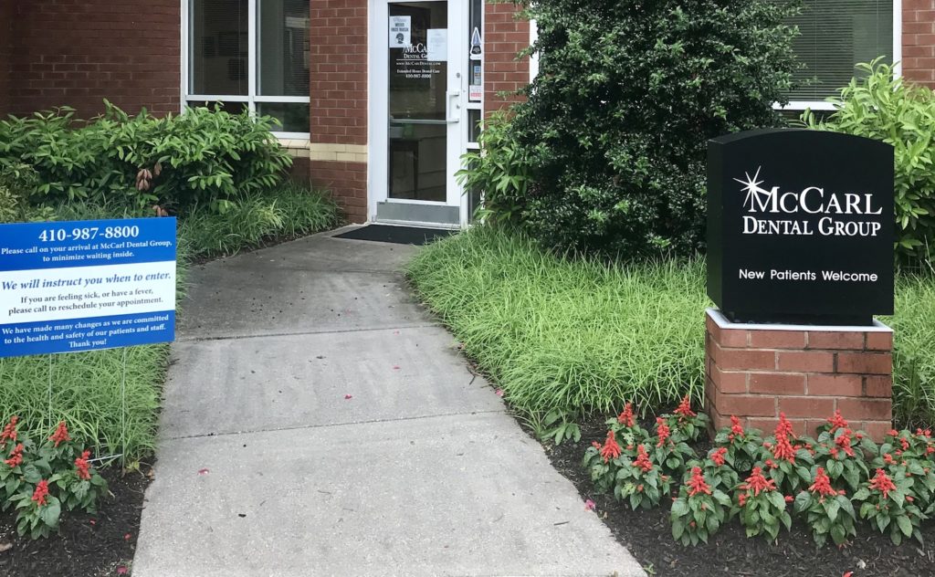 Entrance of McCarl Dental Group in Millersville with social distancing instructions on sign