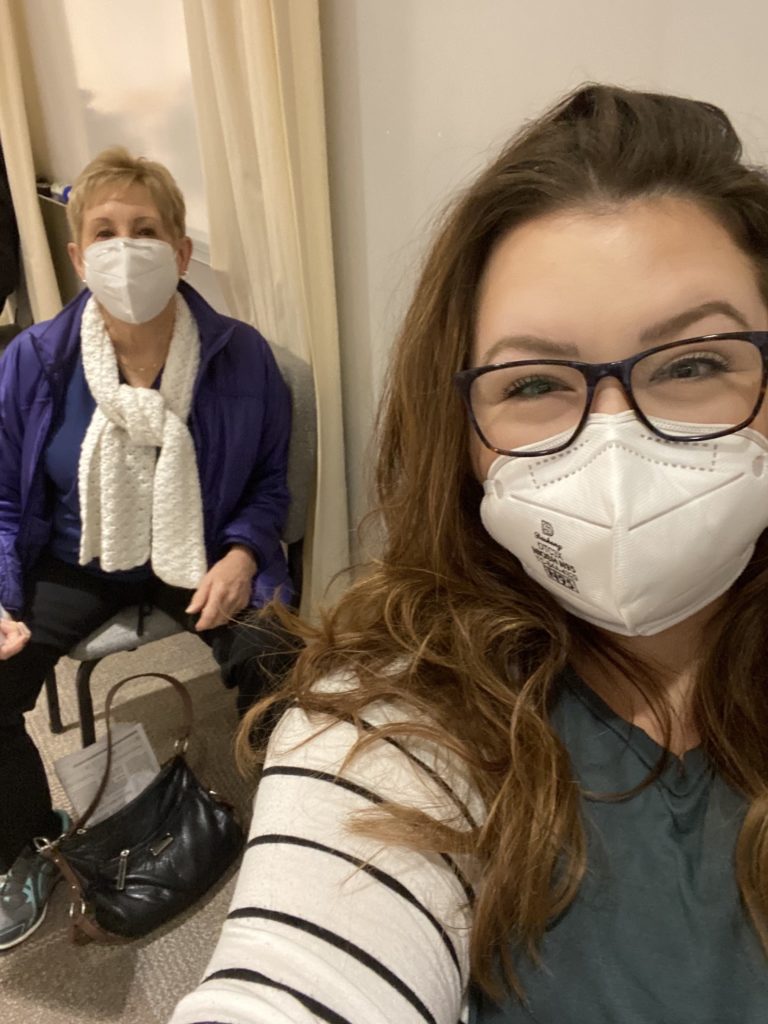 Two dental team members waiting to receive Covid vaccine